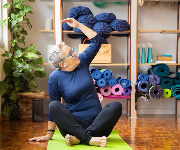 A person in a powerful yoga warrior pose, symbolizing strength and vitality.